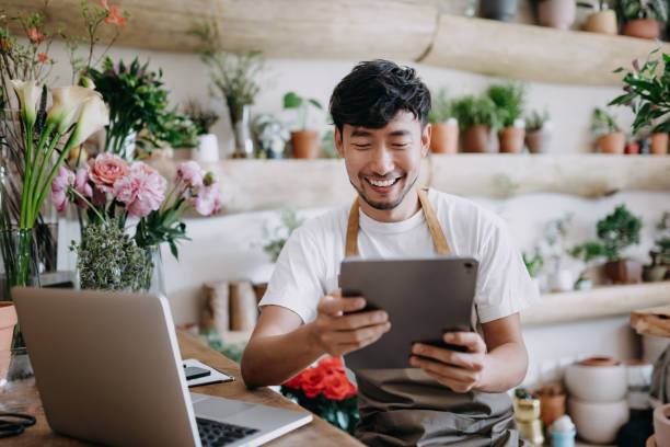 A retail shop owner reviewing his business on a tablet