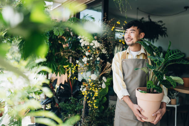 A seasonal shop owner tending to plants