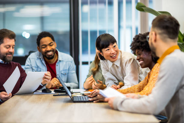 A multi-location team meeting around a table