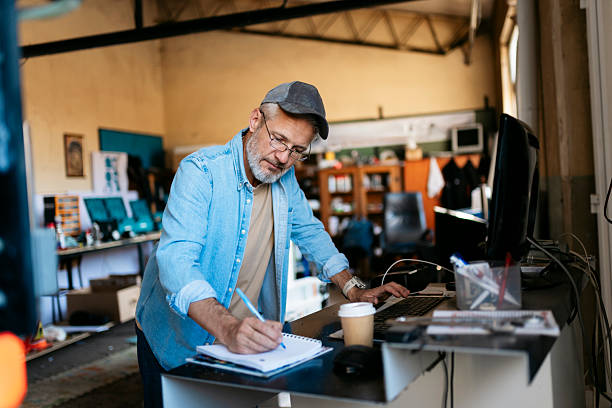 An operator managing logistics from his workshop desk